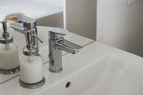 A mixer tap over a white ceramic basin