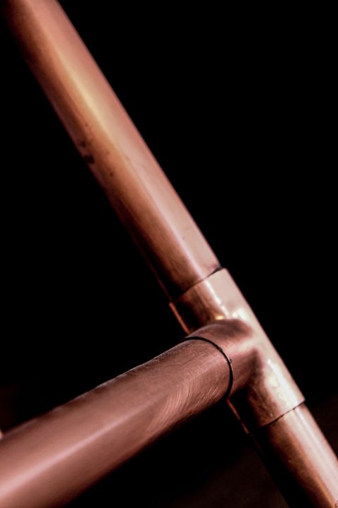 A copper pipe and a soldered tee joint